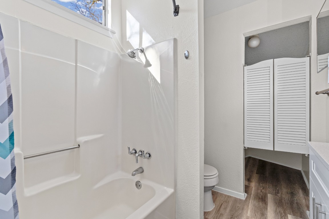 1713 Cinnamon Path, Unit B Austin, TX 78704 - Photo 20 of 32 a bathroom with a granite countertop bathtub shower and toilet