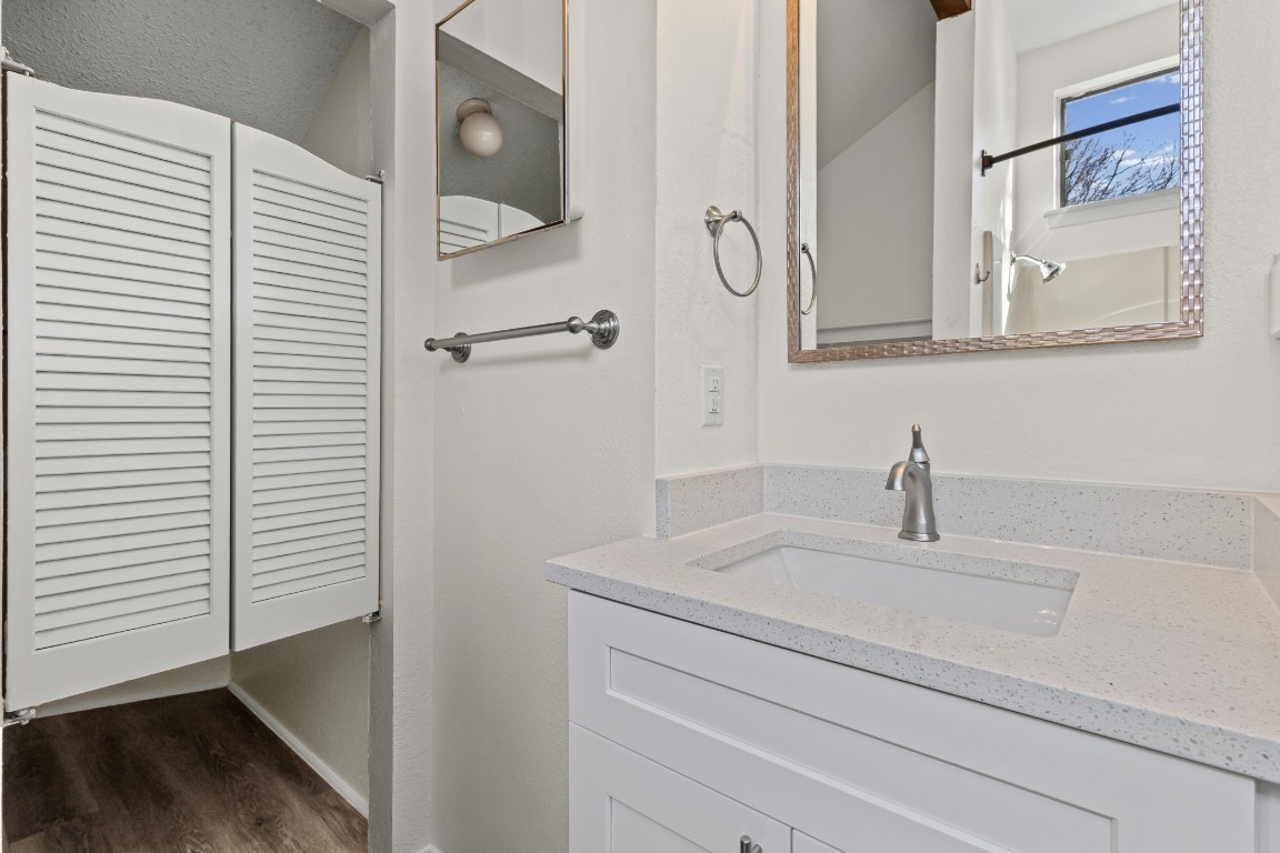 1713 Cinnamon Path, Unit B Austin, TX 78704 - Photo 22 of 32 a bathroom with a sink and a mirror