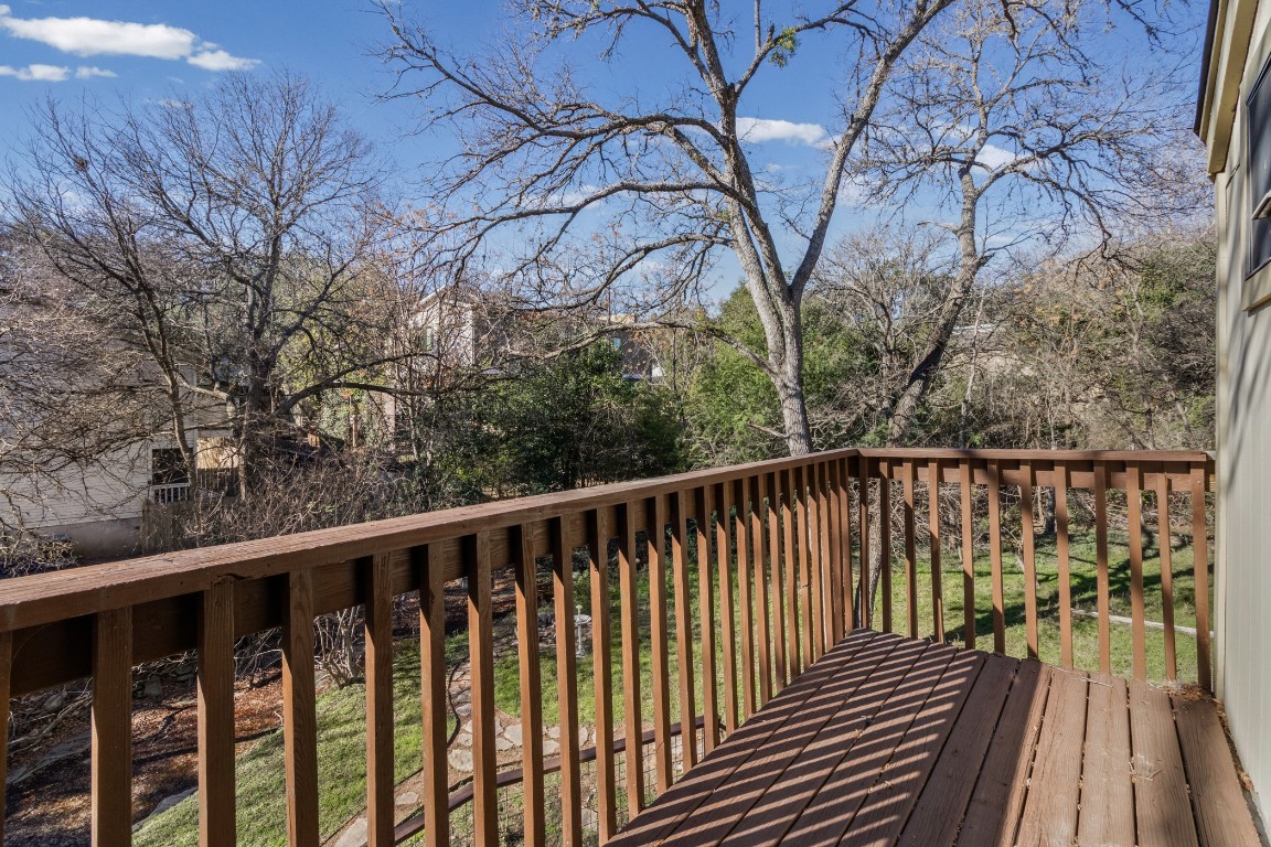 1713 Cinnamon Path, Unit B Austin, TX 78704 - Photo 24 of 32 a balcony with wooden floor and trees