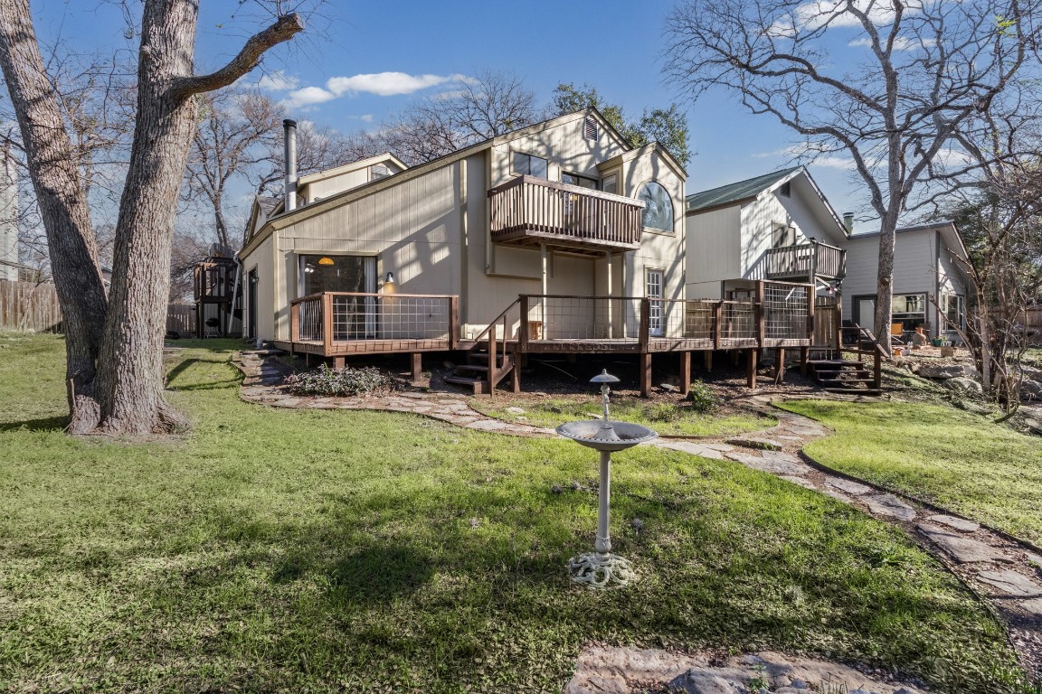 1713 Cinnamon Path, Unit B Austin, TX 78704 - Photo 26 of 32 a front view of a house with a yard table and chairs