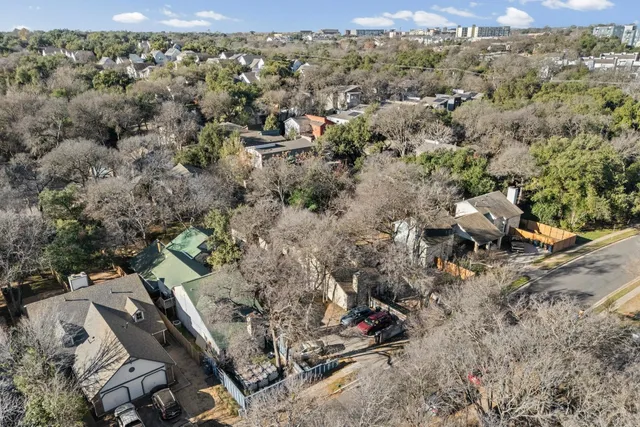 an aerial view of residential houses with city view