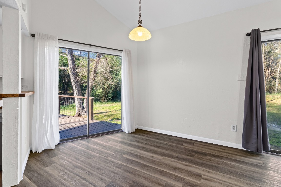 1713 Cinnamon Path, Unit B Austin, TX 78704 - Photo 10 of 32 an empty room with wooden floor and windows