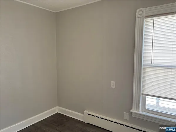 a view of a small space with wooden floor and a window