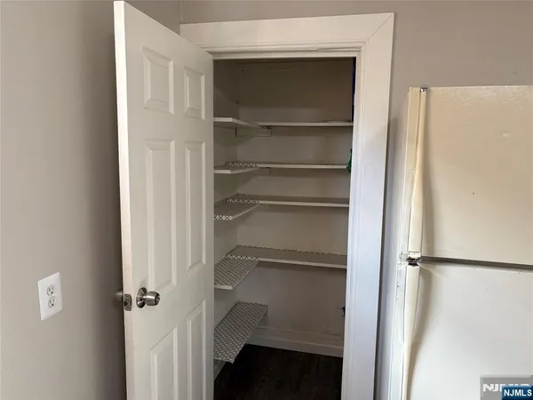 a view of walk in closet with empty racks