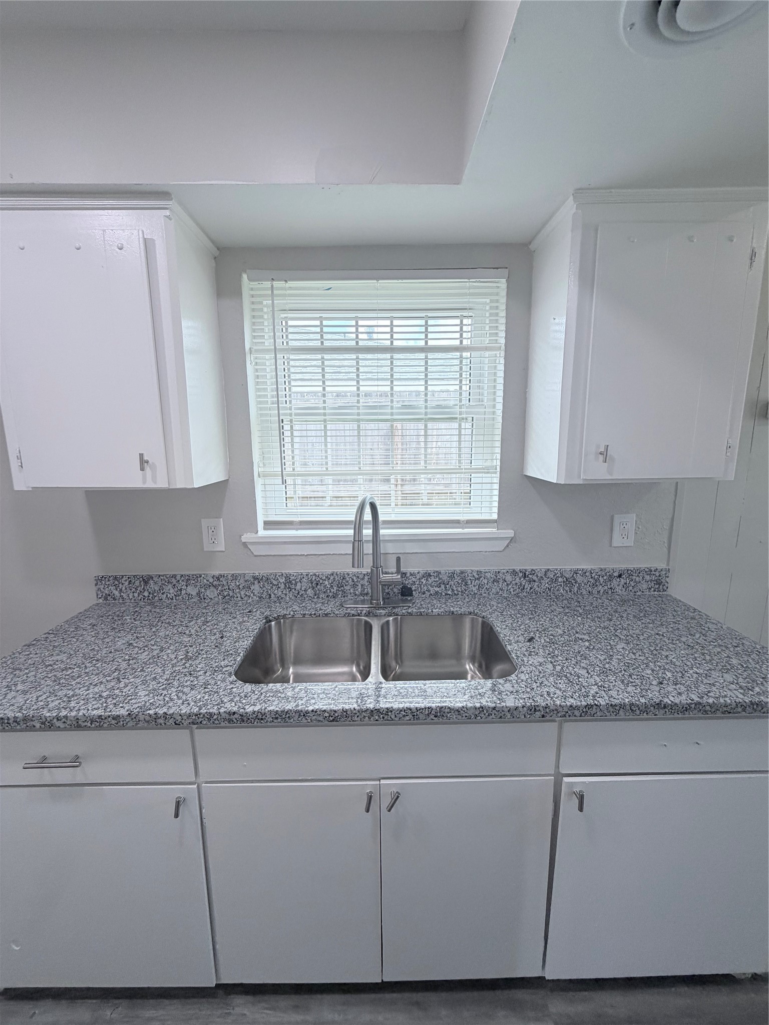 7705 Parker Road Houston, TX 77016 - Photo 11 of 17 a kitchen with granite countertop a sink and a white cabinets