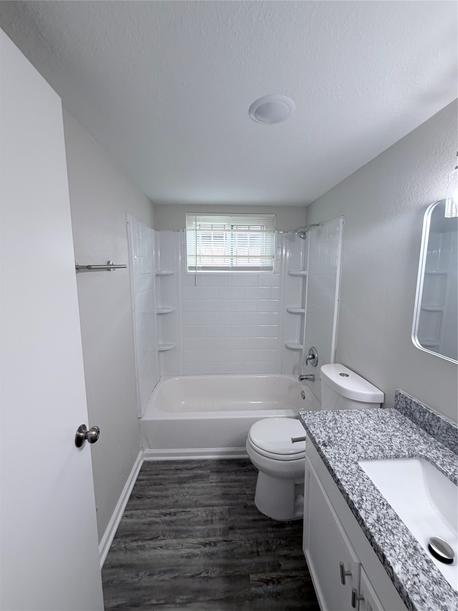 7705 Parker Road Houston, TX 77016 - Photo 12 of 17 a bathroom with a granite countertop toilet a sink and bathtub