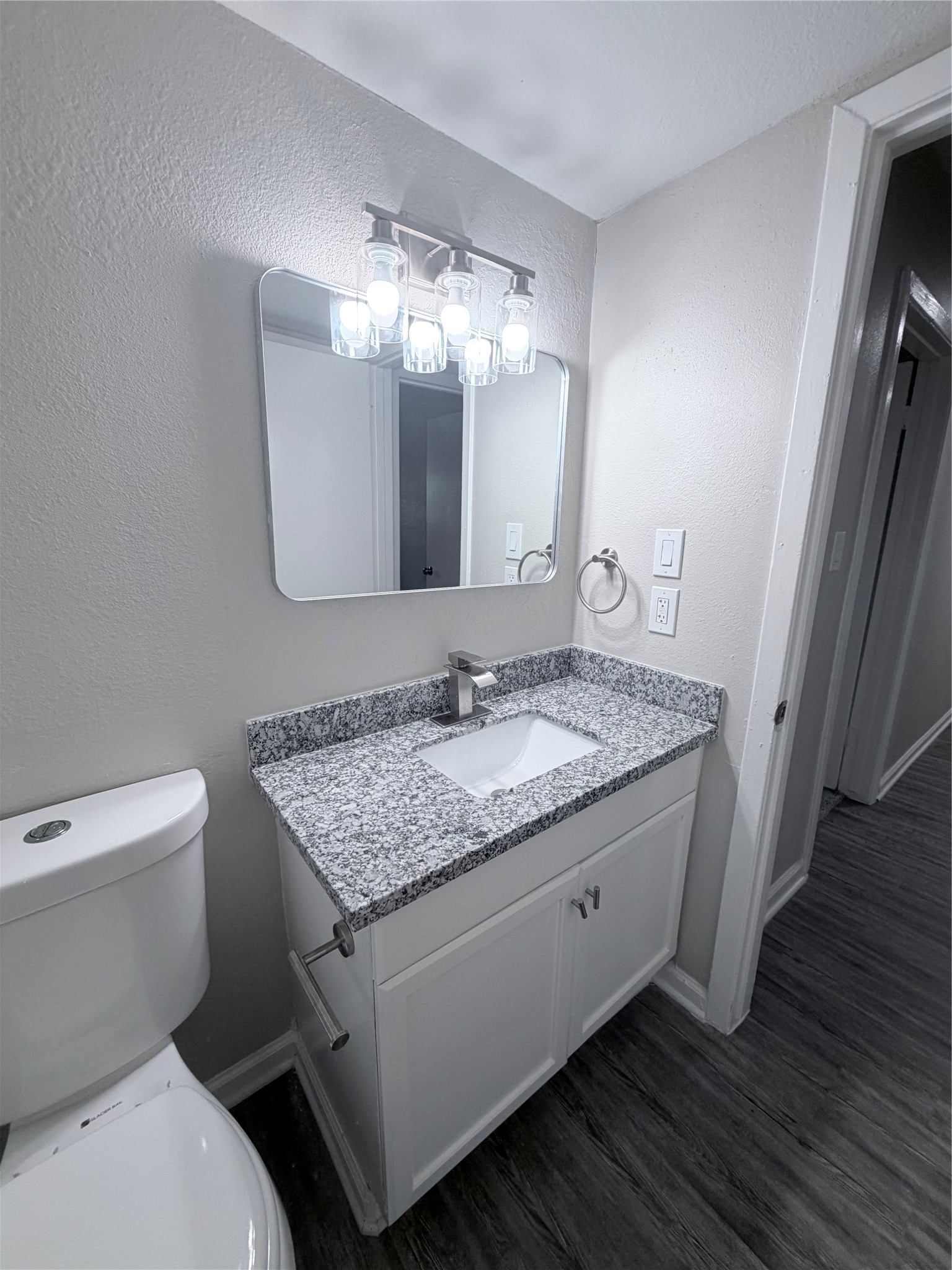 7705 Parker Road Houston, TX 77016 - Photo 17 of 17 a bathroom with a granite countertop toilet sink and mirror
