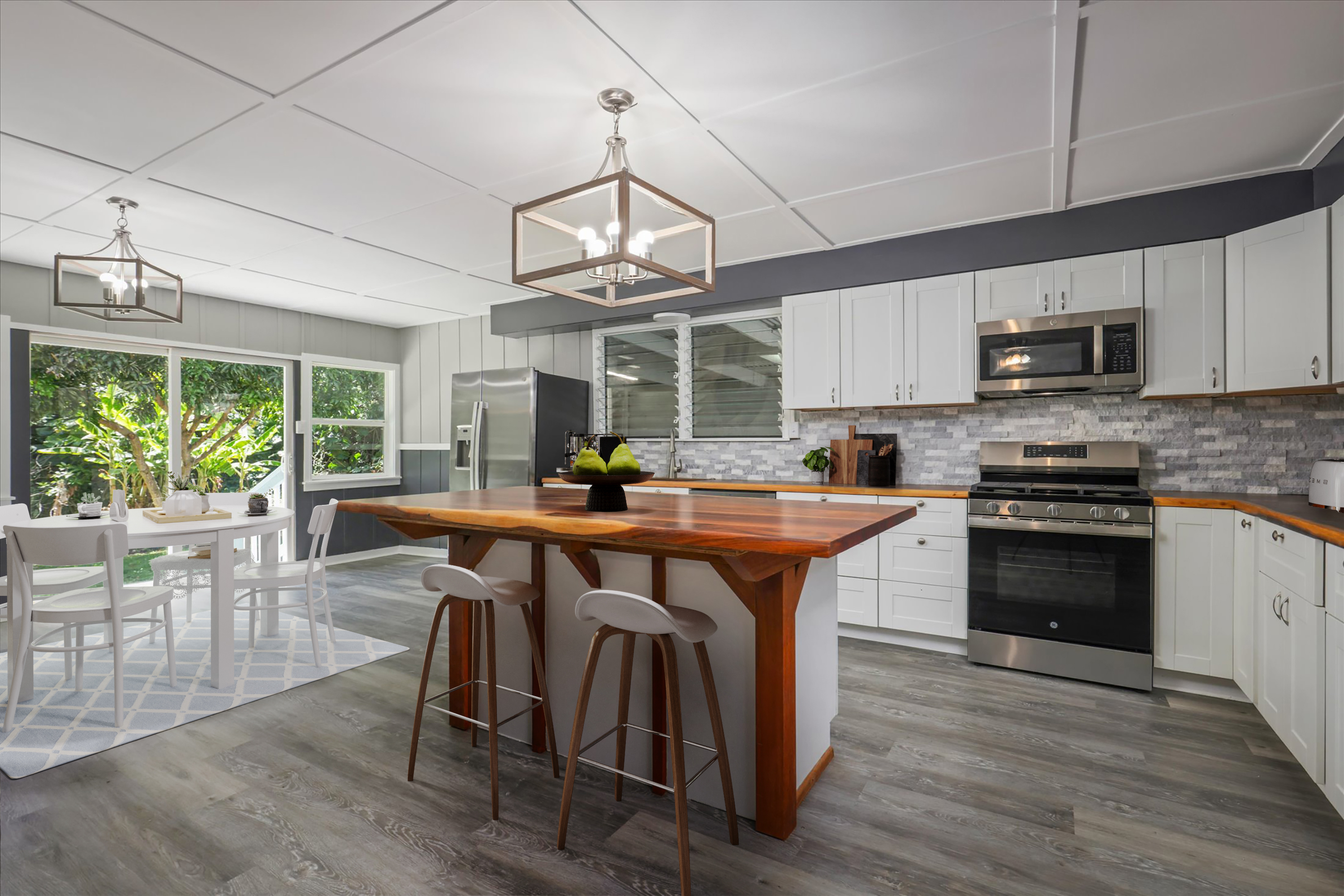 55-545 Hawi Road Hawi, HI 96719 - Photo 4 of 27 a kitchen with stainless steel appliances granite countertop a stove a sink dishwasher a microwave oven with a dining table and chairs with wooden floor