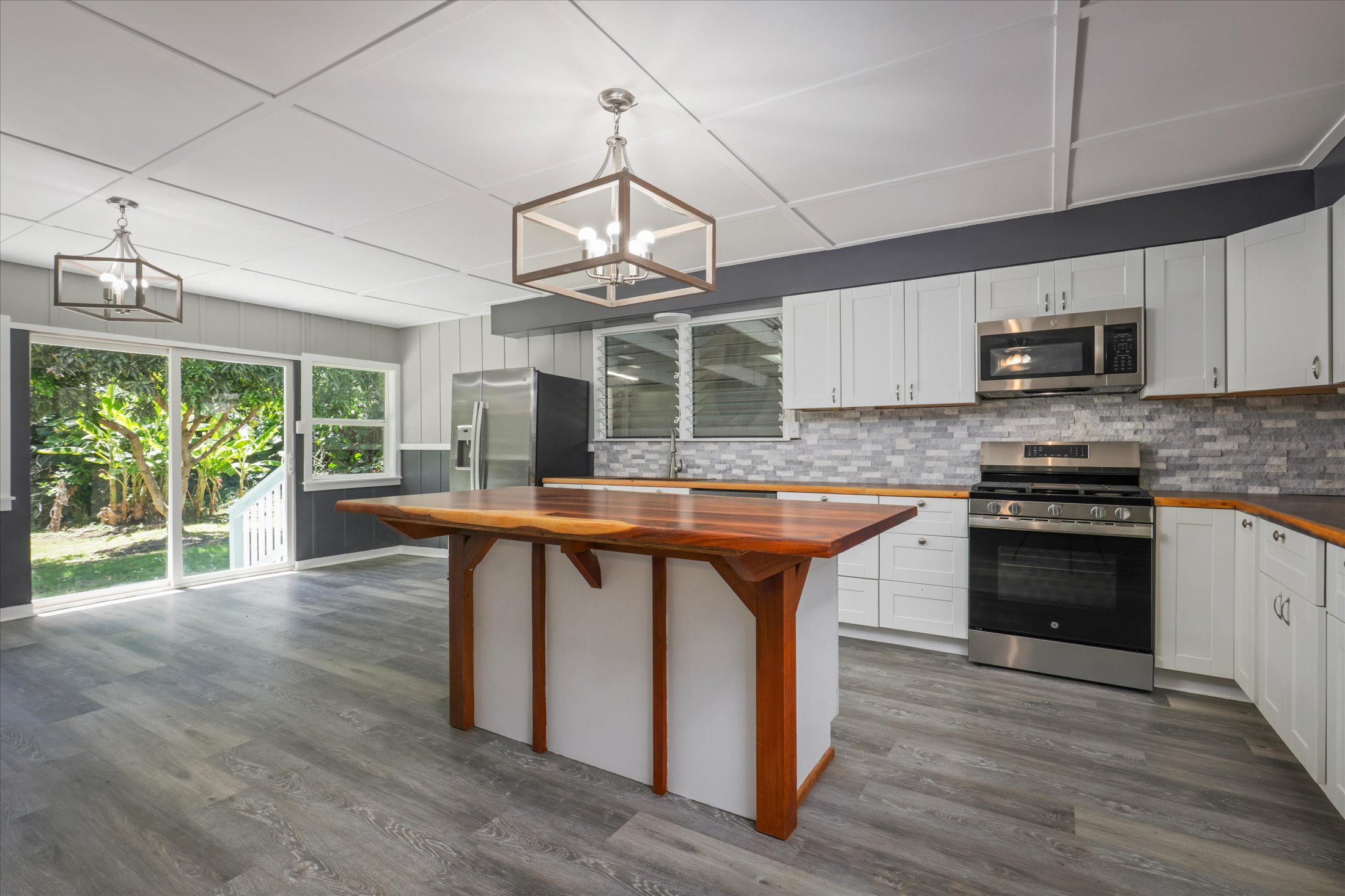55-545 Hawi Road Hawi, HI 96719 - Photo 5 of 27 a kitchen with kitchen island granite countertop a stove top oven a sink a counter space and cabinets