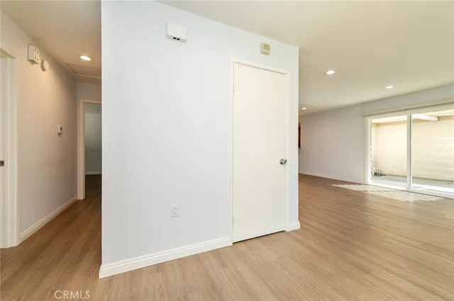 a view of a room with wooden floor