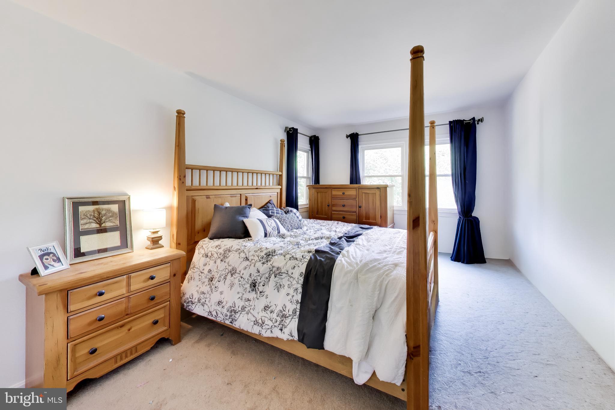 3240 Juniper Lane Huntingtown, MD 20639 - Photo 12 of 48 a bedroom with a bed and large windows
