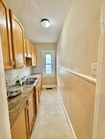 a kitchen with stainless steel appliances granite countertop a sink and a stove