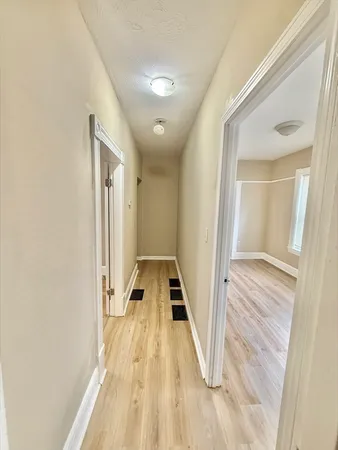 a view of a bathroom with a sink and wooden floor