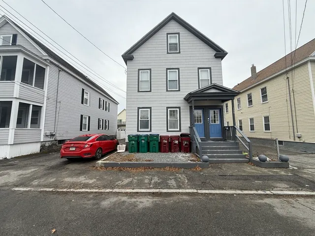 a front view of a house with a garden