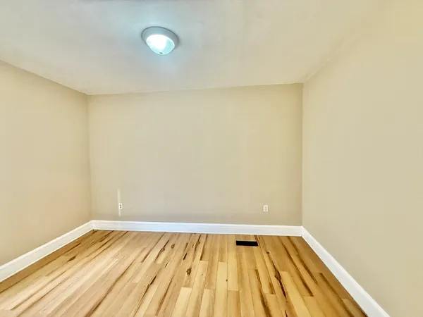a view of a room with wooden floor and tiles