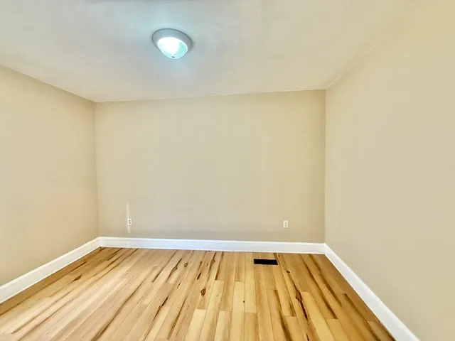 a view of a room with wooden floor and tiles