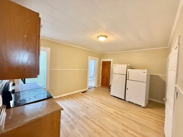 a view of a room with wooden floor