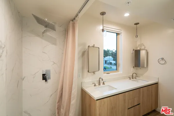 a bathroom with 2 sink and a mirror