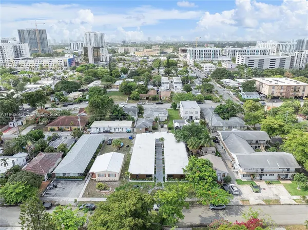 an aerial view of residential houses with city view