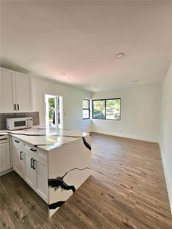 a living room with granite countertop furniture and a window