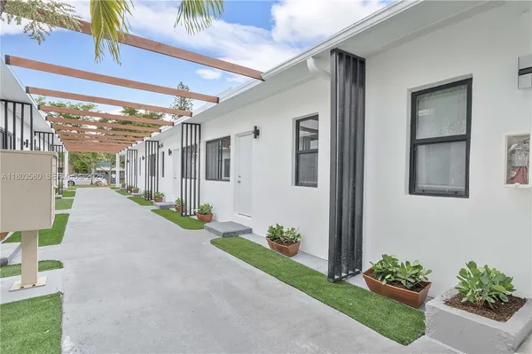a view of a porch with potted plants