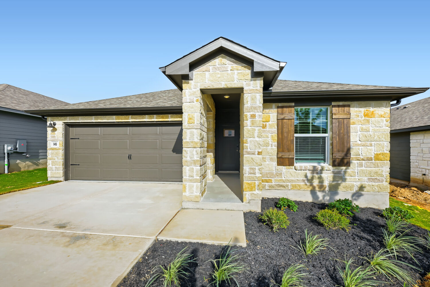 146 Diablo Rim Terrace Dripping Springs, TX 78620 - Photo 31 of 32 A charming stone facade with wood shutters welcomes you to this inviting residence.