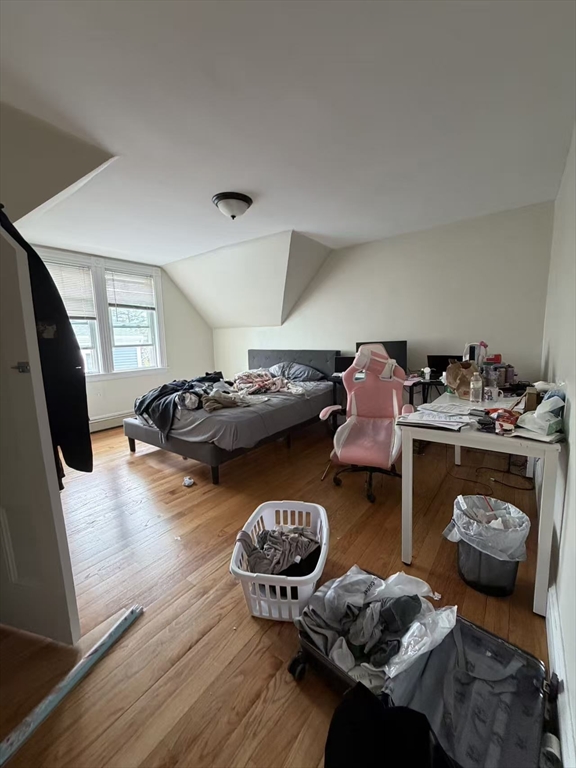 35 Fiske Street, Unit 3 Waltham, MA 02451 - Photo 4 of 6 a bedroom with furniture and a wooden floor
