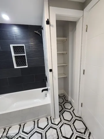 a bathroom with a bathtub and a shower