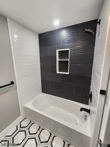 a bathroom with a bathtub and shower