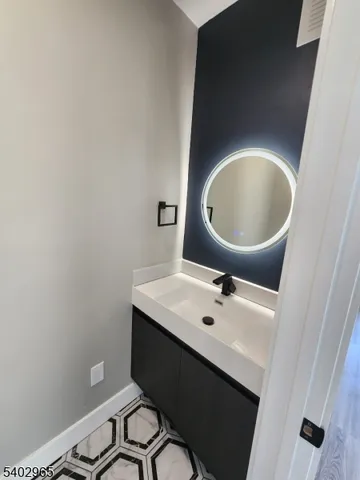 a bathroom with a sink toilet and mirror