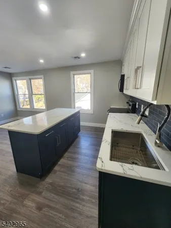 a kitchen with a sink and a stove top oven
