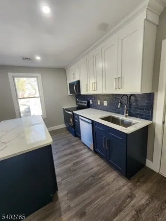 a kitchen with a sink a stove and cabinets