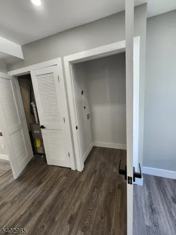 an empty room with wooden floor and a ceiling fan