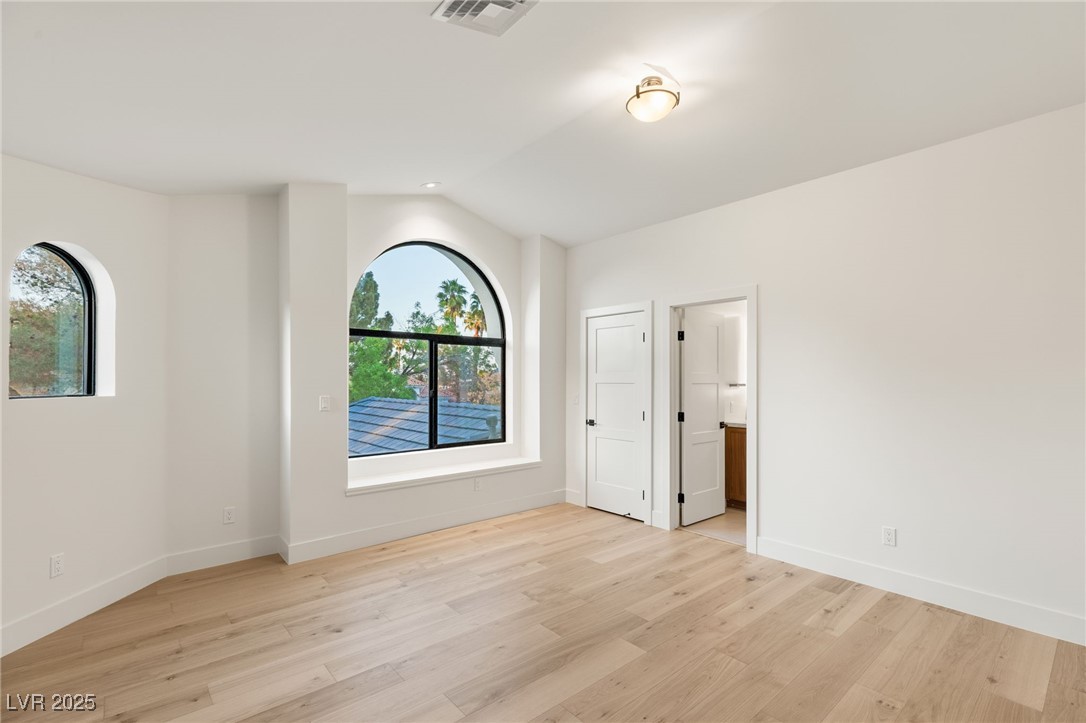 2316 Prometheus Court Henderson, NV 89074 - Photo 45 of 92 Spare room featuring visible vents, light wood-type flooring, and a healthy amount of sunlight