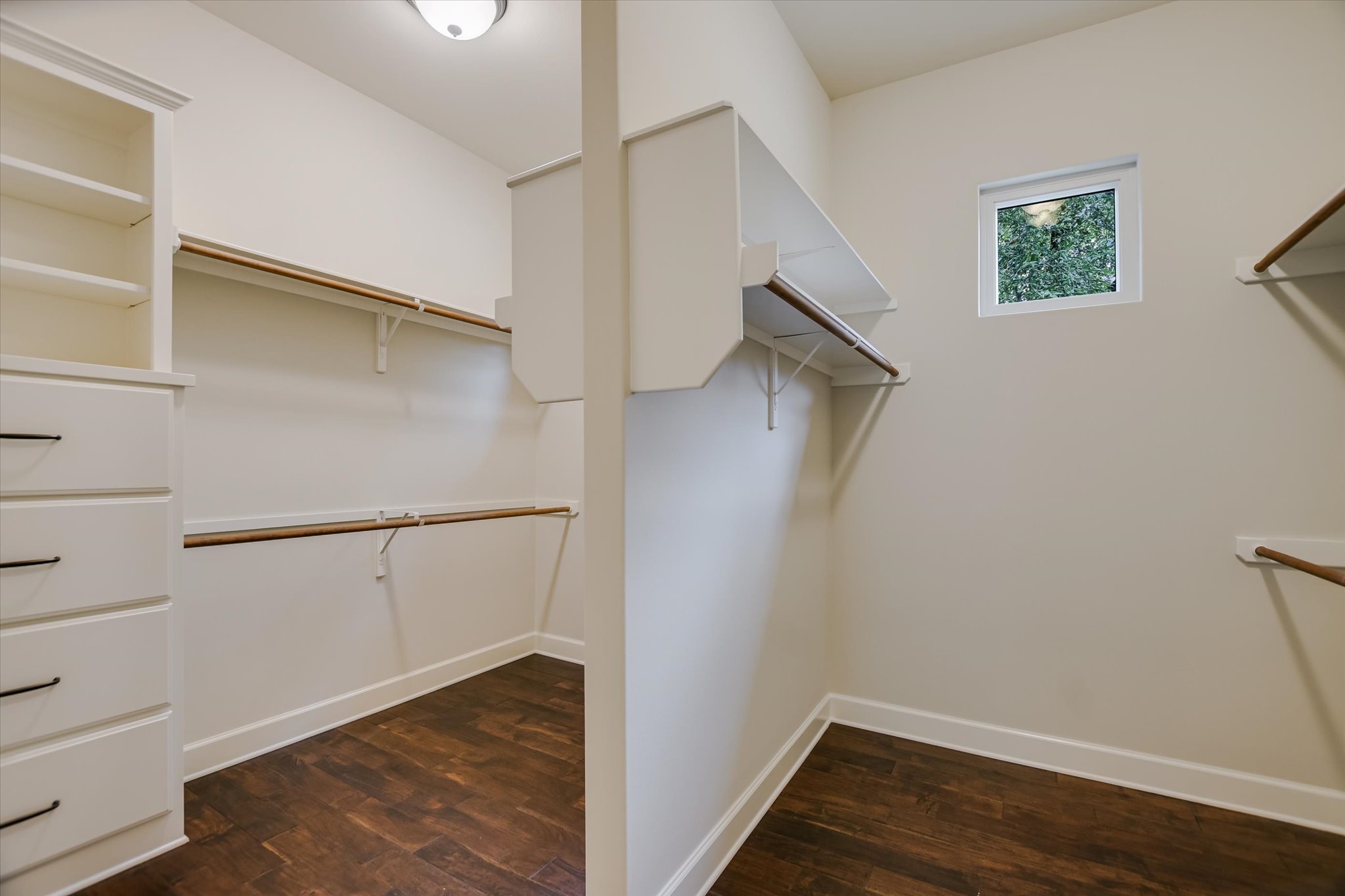 11 Inwood Circle Austin, TX 78746 - Photo 22 of 38 Primary Closet offers Ample storage solutions include built-in shelving, drawers, and generous hanging space.