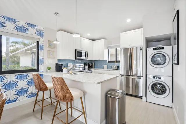 a bedroom with a bed and a flat tv screen on dresser