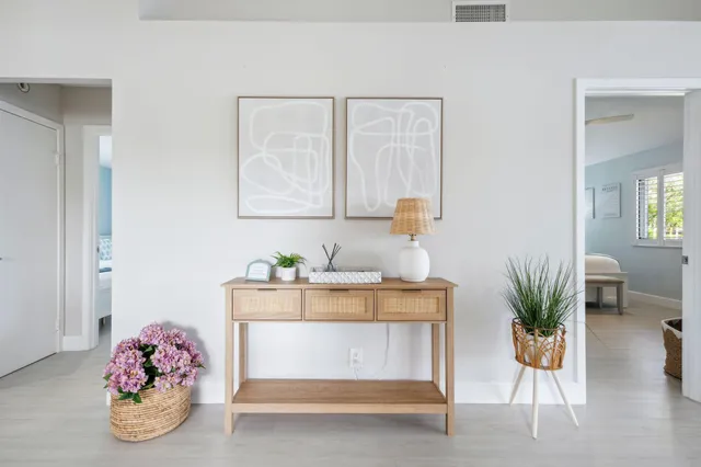 a bedroom with a large bed and a flat tv screen
