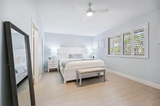 a spacious bedroom with two beds and large window