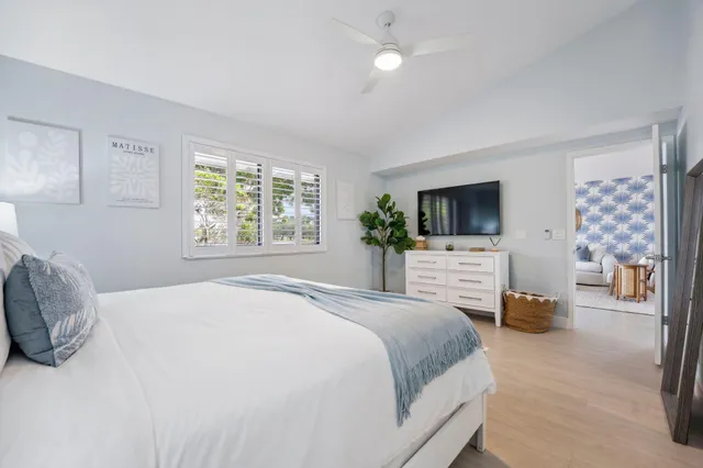 a bedroom with two beds and a large window