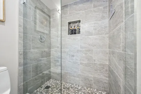 a bathroom with a sink a toilet and shower