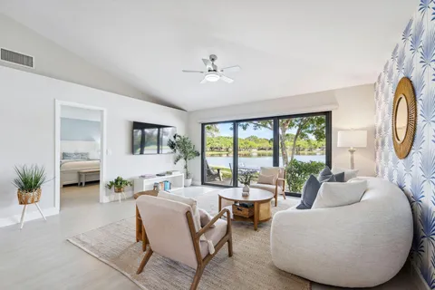 a living room with furniture and a floor to ceiling window