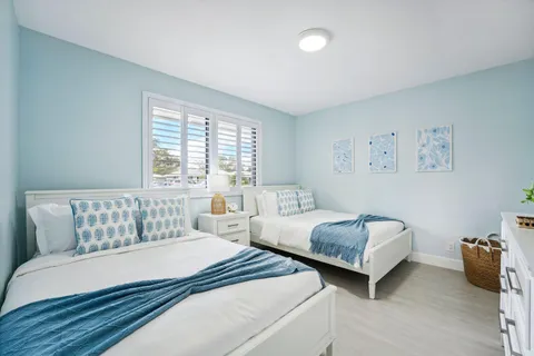 a view of house with backyard and outdoor seating