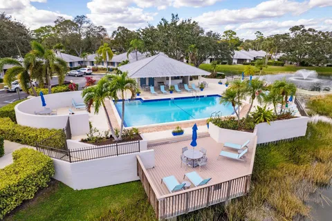 a view of a house with backyard and sitting area