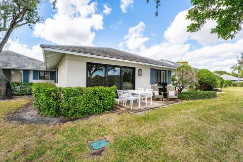 an aerial view of a house with a swimming pool outdoor seating and yard