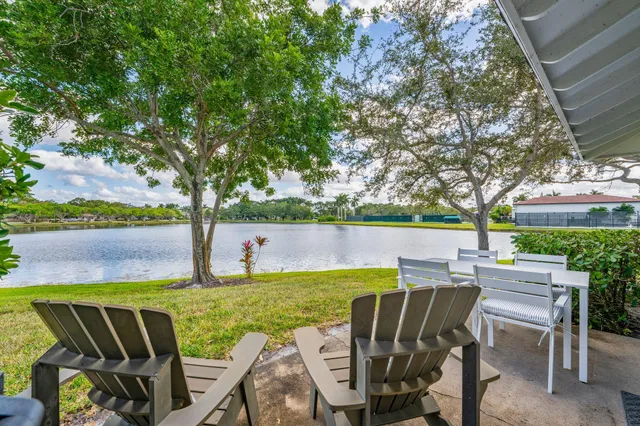 a view of a fountain in front of a house with a big yard