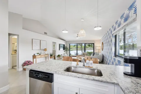 a kitchen with stainless steel appliances a stove a sink and a refrigerator