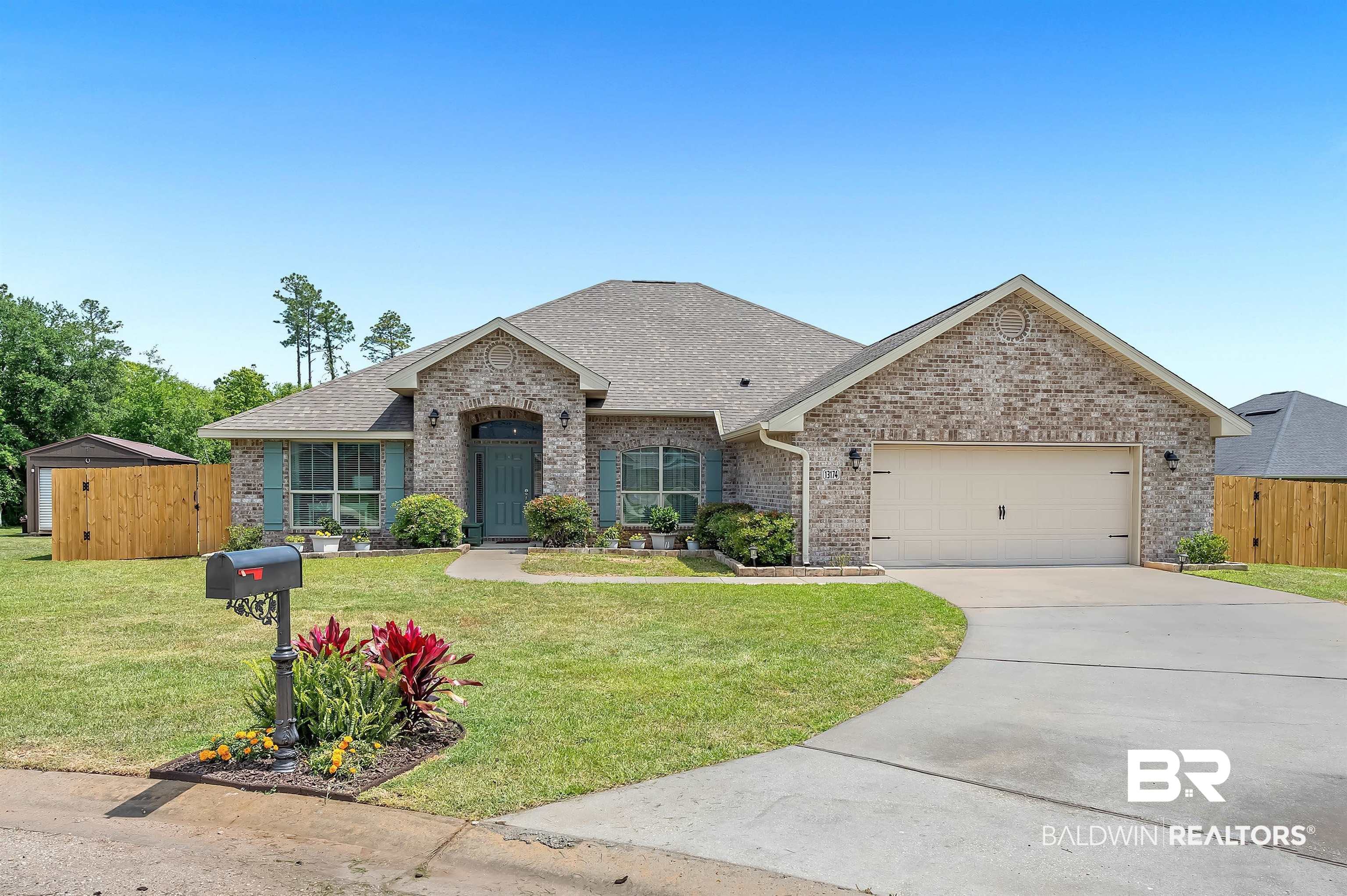 13174 Royster Court Foley, AL 36535 - Photo 1 of 1 View of front facade featuring brick siding, driveway, a garage, and a front lawn