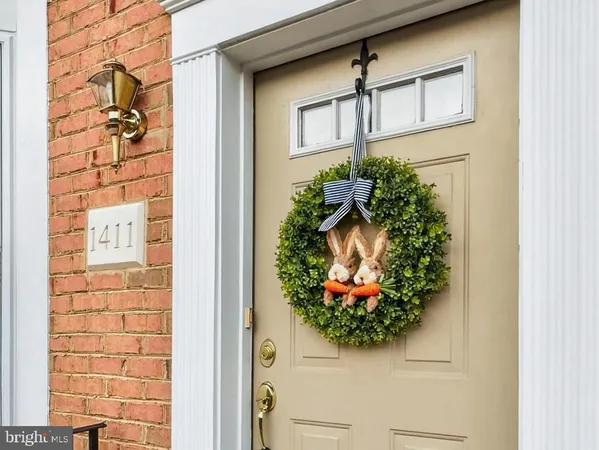 a front view of a house with a potted plant