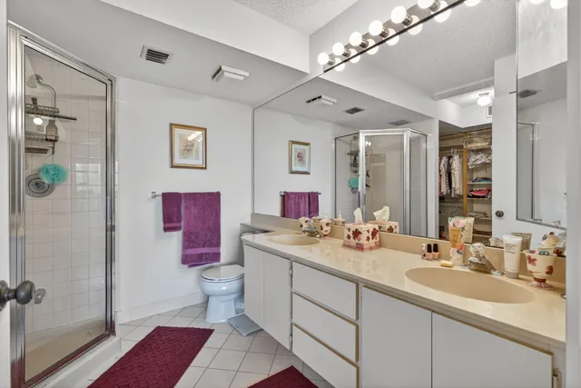 a bathroom with a sink vanity mirror and toilet