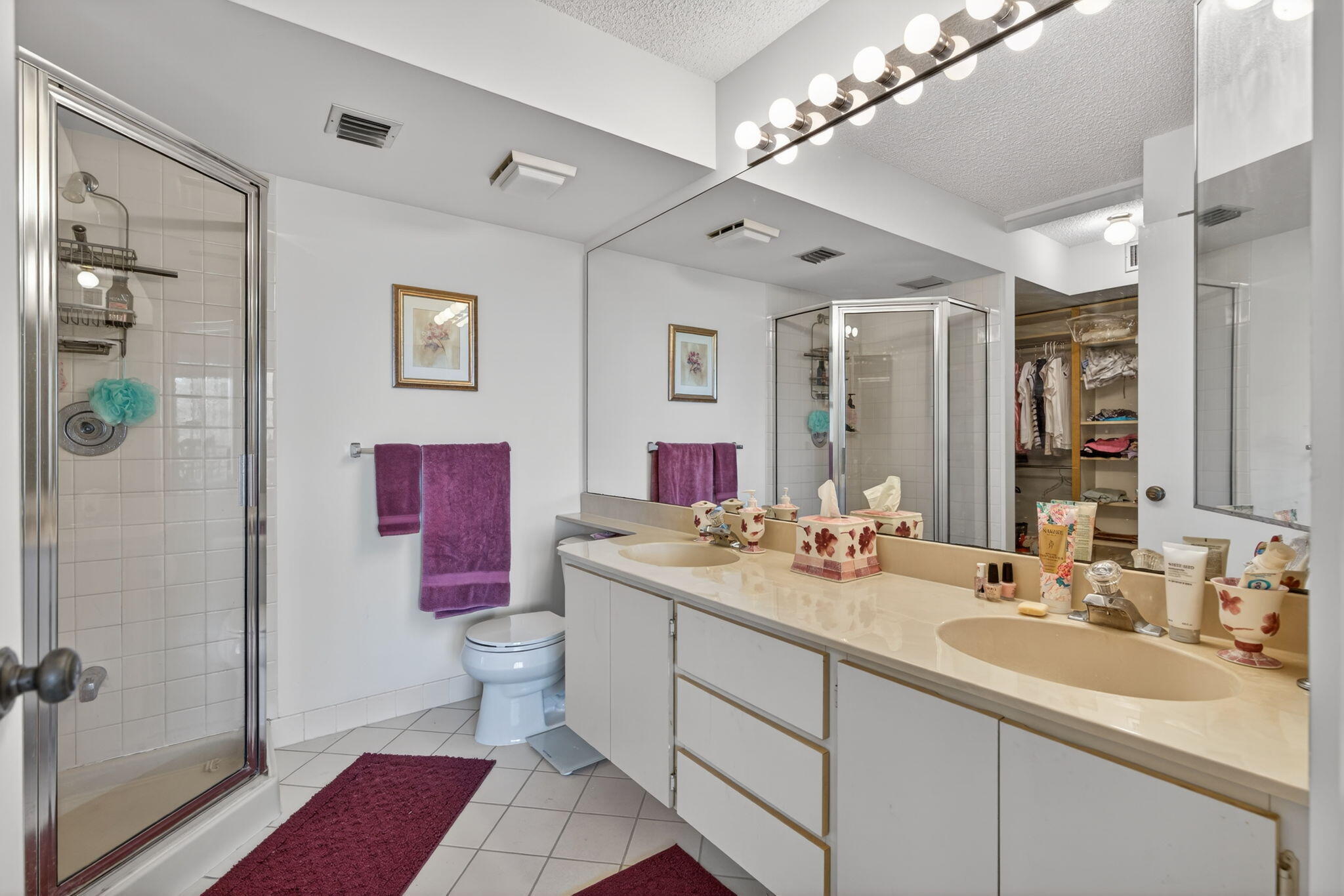 2581 Village Boulevard, Unit 401 West Palm Beach, FL 33409 - Photo 13 of 24 a bathroom with a sink vanity mirror and toilet